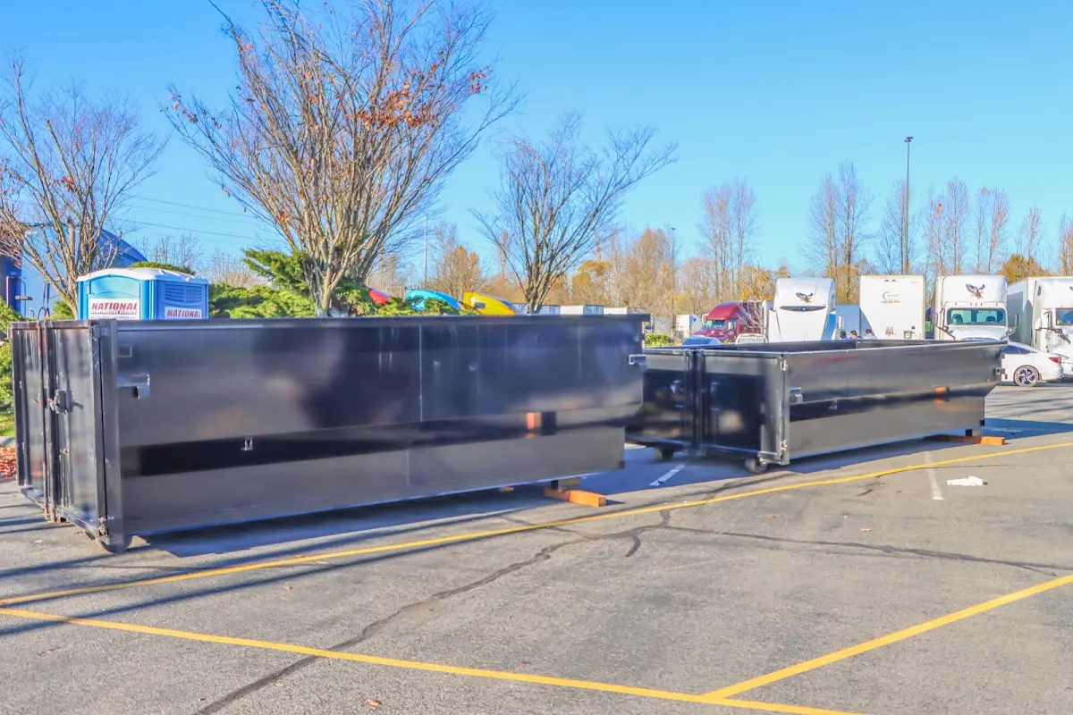 Professional dumpster rental service with roll-off container on residential driveway in Meraux